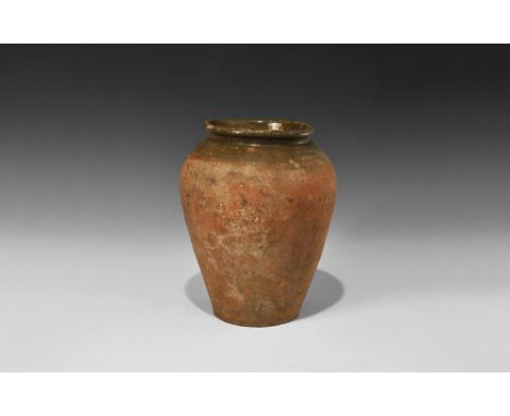 14th century AD.A large tall glazed ceramic storage jar with flat bottom, high shoulder and everted rolled rim; brown glaze t