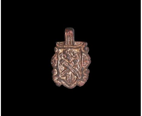 9th-10th century AD.   An gilt-copper-alloy rectangular pendant, obverse decorated with inlaid motif of a bird, possibly a ra