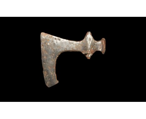 11th century AD.   An iron axehead with lateral spurs to the socket, triangular-section blade with lower extension and spur t