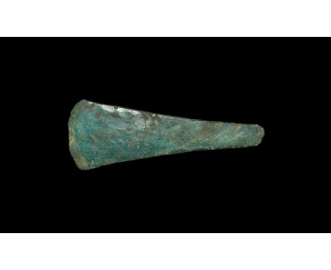 Late 3rd millennium BC.   An Early Bronze Age copper flat axe of rectangular section, expanding from a narrow rounded butt to