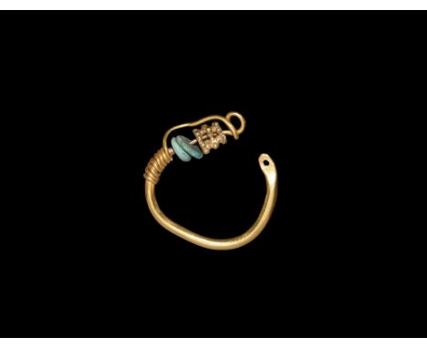 2nd-3rd century AD.   A gold earring comprising a round-section penannular hoop with one pierced finial, the other a fine wir