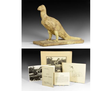 Circa 1930.   A surface-treated plaster master model of an Iguanadon advancing on a rectangular textured base with head raise