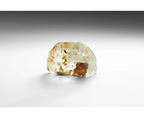 A large crystal of topaz exhibiting a number of faces and a classic topaz cleavage plane; in old white card tray. See Bonewit