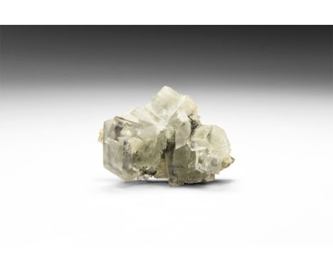 A specimen of unusual, nearly colourless fluorite cubes from Cumbria, UK; in old white card tray, inked collection number to 
