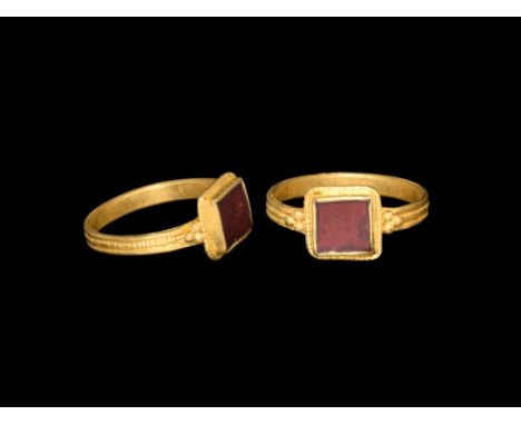 5th century AD.   A flat-section gold hoop with beaded median band, square bezel with cluster of three granules to each shoul