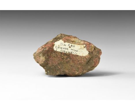 A specimen of Cornish cassiterite tin ore in massive form; in white card tray with Tipex label reading: 'Tin Ore, Geevor Mine