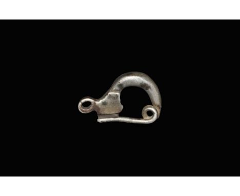 5th century BC.A silver fibula comprising a thick, rectangular-section bow with rectangular foot and catchplate; the upper en