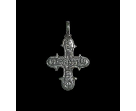 6th-8th century AD.A cruciform bronze pendant with pierced lug above, lateral spurs to each arm, enigmatic inscription 'БФІФ'
