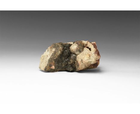 A matrix specimen of siderite with accessory haematite; in white card tray with adhesive tape label reading: 'SIDERITE, HEMAT