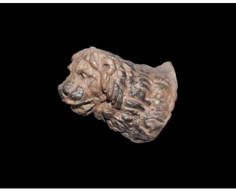 15th-16th century AD.   A ceramic fitting in the form of a lion head with slightly open mouth revealing teeth, detailing to t