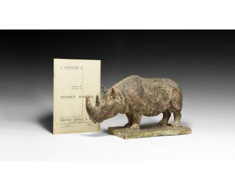 Circa 1935.   A surface-treated plaster model of a woolly rhinoceros on a rectangular textured base; pamphlet A Catalogue of 