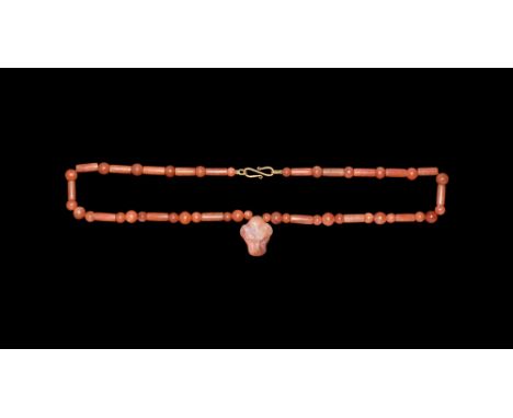New Kingdom, 18th Dynasty, 1549-1292 BC. A restrung necklace of carnelian beads, cylindrical and spherical in shape, with a c