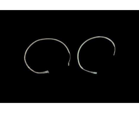 8th-4th century BC.A pair of bronze torcs consisting of a twisted rod with flattened rectangular ends, one with the terminals