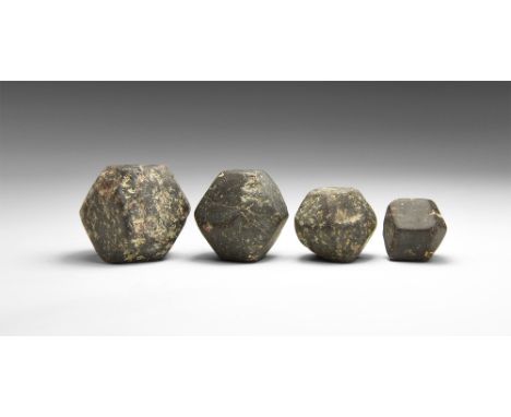 A group of four dodecahedral garnet crystals in graded sizes, probably almandine; in old white card tray. See Bonewitz, Dr. R