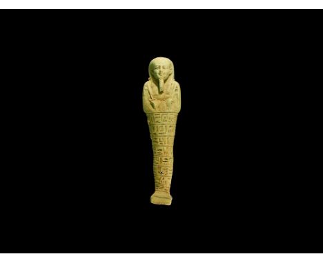 26th Dynasty, 664-525 BC. A glazed composition shabti with mummiform body, wearing tripartite wig and false beard, arms cross