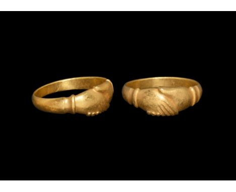 16th-17th century AD.   A flat-section gold hoop with bezel formed as two clasped hands with scooped cuffs. See Chadour, A.B.