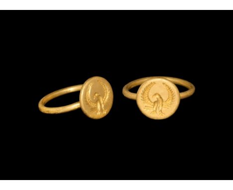 1st-2nd century AD.   A round-section gold hoop supporting a discoid bezel with intaglio eagle with wings spread and curved. 