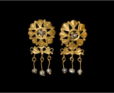 2nd-3rd century AD.   A pair of gold earrings with sunburst-shaped shield with pearl to the centre; to the bottom a butterfly