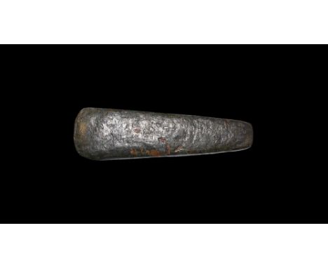 2nd millennium BC.A copper axe blade with square butt and curved edge, slight chamfer above the edge. See Schmidt, P.K. & Bur