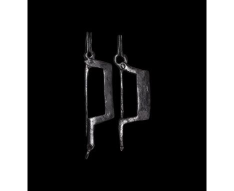 2nd-3rd century AD.A pair of iron pincer brooches, each a flat-section bow with integral catchplate, hinged pin forming a pin
