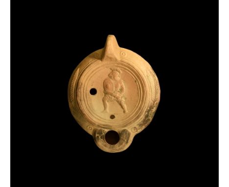 2nd century AD.A ceramic oil lamp with multiple ring shoulder decorated to the outer edge with victory palm fronds and rounde