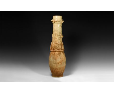 Song Dynasty, 960-1127 AD.A cream-glazed ceramic granary jar with rosette appliqués and undulating dragon to the neck above a