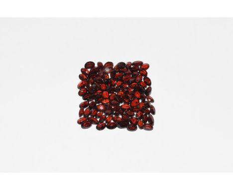 A group of one hundred oval-cut garnets of a deep red colour, approximately 110 carats in total. 22 grams total, approximatel