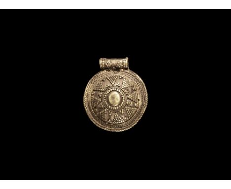 9th-12th century AD.   A sheet silver domed pendant with applied wires to the suspension loop and reverse; filigree and granu