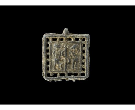 30 BC-323 AD.   A rectangular flat-section lead-alloy pendant with loop and openwork border, central plaque with high-relief 