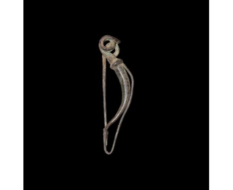 2nd-1st century BC. A bronze bow brooch of La Tène Type II with coiled spring, integral bow with returned foot attached to a 