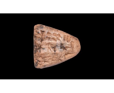 7th century BC.A ceramic triangular-shaped tag with seal impression and inscription to both faces. 6 grams, 24mm (1").Fine co