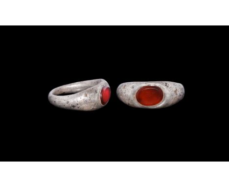 1st century AD.   A D-section silver hoop with flared shoulders, plaque with inset carnelian cabochon. Cf. Chadour, A.B. Ring