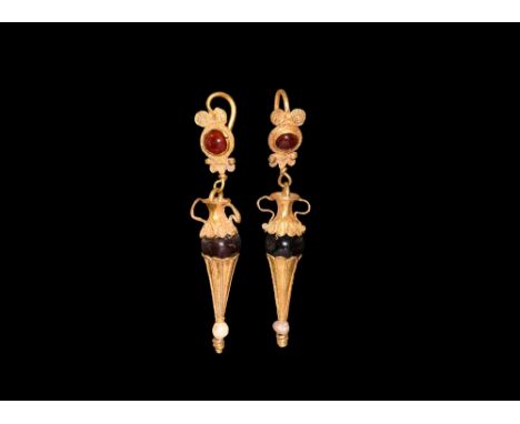 4th-2nd century BC. A pair of gold earring drops in the shape of amphora with garnet bodies, the base in the form of a fluted