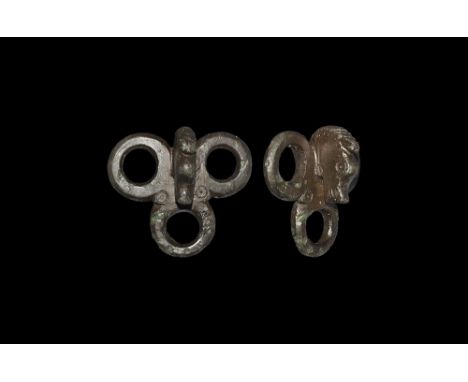 1st century BC-1st century AD.   A bronze strap junction comprising three conjoined loops and a horse-head between with ring-