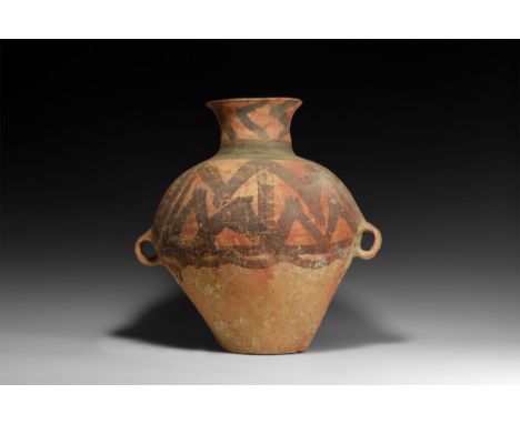 3rd millennium BC.A bulbous ceramic jar with two small loop handles, narrow base and trumpet-shaped rim; decorated to the upp