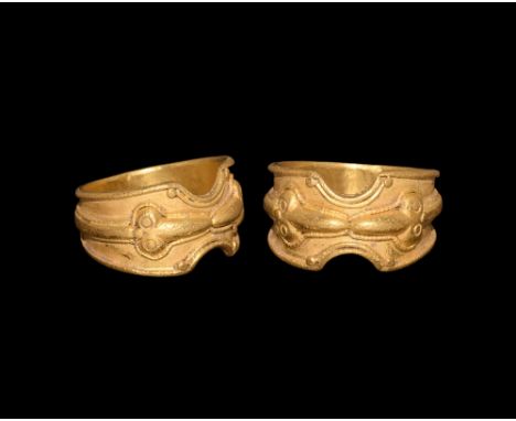 8th-10th century AD.   A flat-section gold hoop with rolled edges, scooped slots with applied beaded wire and granules, raise