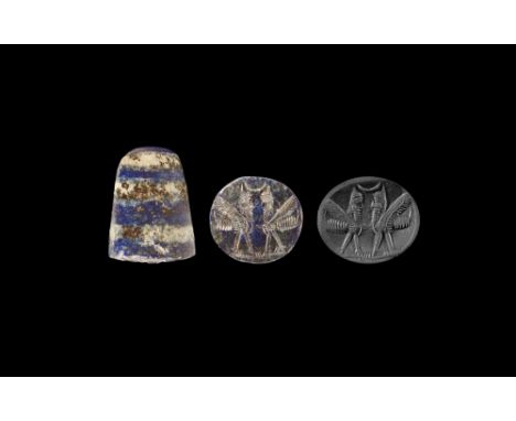 Early 1st millennium BC.A banded lapis lazuli tapering column pierced for suspension; design of a pair of opposed human-heade