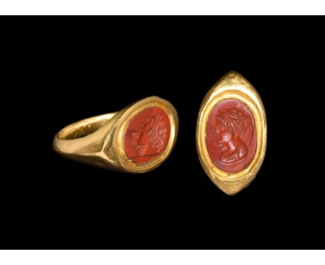 3rd-4th century AD.   A keeled D-section gold hoop with flat angled shoulders, scaphoid bezel with inset red jasper cloison, 