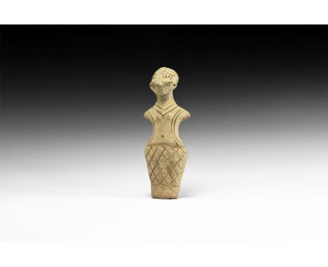 Neolithic, 6th-4th millennium BC.A ceramic figure of a standing female with prominent nose and hair, stub arms extended, inci
