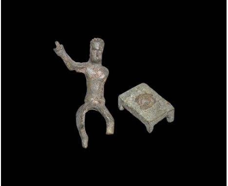1st century AD.A bronze figure of a male, hair swept back, pellet eyes and small nose; wearing a tunic flared at the base to 
