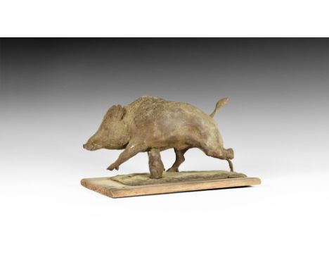 Circa 1930.   A model of a running boar on a rectangular base and wooden plinth directly carved by Vernon Edwards, incised wi