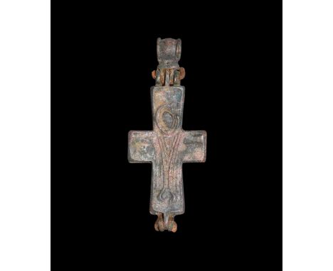 7th-9th century AD.A bronze two-part cruciform pendant with hinge and suspension loop; to both faces a robed nimbate figure w