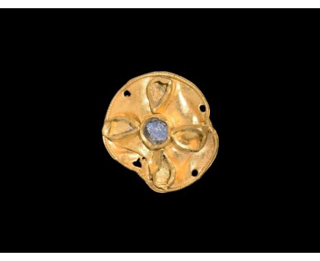 6th-9th century AD.A flat discoid gold mount with four holes for attachment pins, beaded wire border, central annular cell an