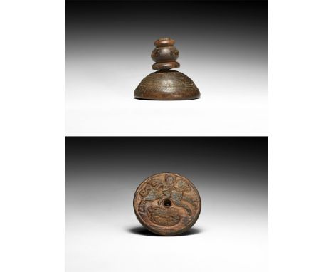 6th-9th century AD.A wooden stamp comprising a plano-convex base and balustered knop handle; carved image to the underside of