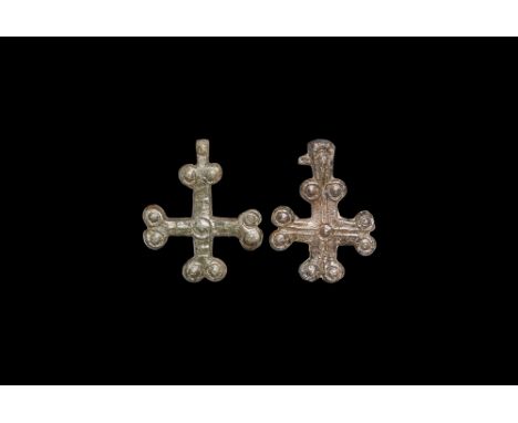 6th-9th century AD.   A mixed pair of bronze flat-section cross pendants, each with two pellets to the end of each arm. 27 gr