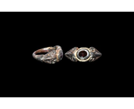 2nd-3rd century AD.A gilt bronze ring with D-section hoop expanding at the shoulders, angled in to the bezel in the form of a