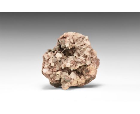 An unusual specimen of nailhead calcites encrusting a groundmass of haematite; in white card tray with adhesive tape label re
