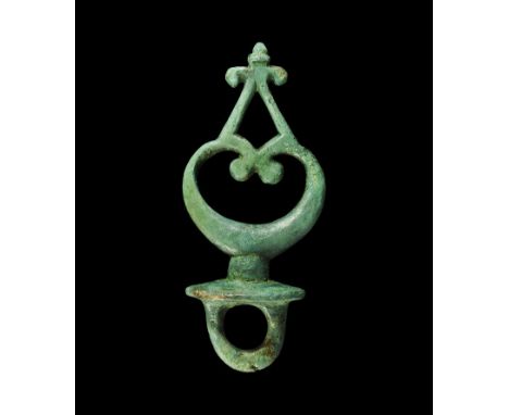 1st century AD.A cast terret with central crescent motif, scrolled ends and chevron above with trefoil finial; beneath, an el
