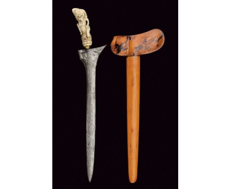 A kris dating: first quarter of the 20th Century provenance: Bali Double-edged blade; bone grip, finely sculpted wth a deity;