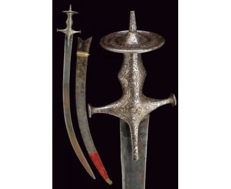 A silver mounted tulwar dating: 19th Century provenance: India Curved, single-and false-edged blade, of flat section, made of